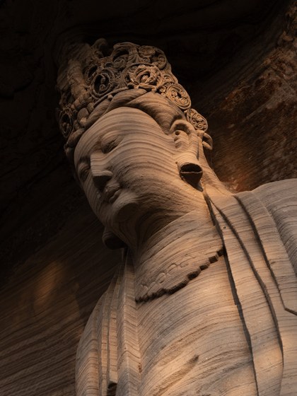 Stone bodhisattva sculpture, close-up of the face and crown